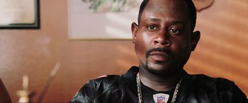 Movie still from “Bad Boys II” (2003), directed by Michael Bay – A person wearing a football jersey; Close Up shot, High angle