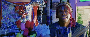 Movie still from “Bad Boys II” (2003), directed by Michael Bay – A young man standing in front of a bunch of flowers; Close Up shot, Low angle