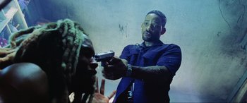 Movie still from “Bad Boys II” (2003), directed by Michael Bay – A man holding a gun pointed at another man's face; Close Up shot, Low angle