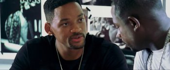 Movie still from “Bad Boys II” (2003), directed by Michael Bay – A man in a black shirt is talking to someone; Close Up shot, Over the shoulder angle