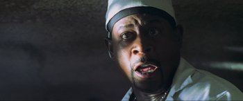 Movie still from “Bad Boys II” (2003), directed by Michael Bay – A person wearing a hat; Close Up shot, Low angle