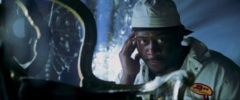 Movie still from “Bad Boys II” (2003), directed by Michael Bay – A man in a white hat looking at his reflection in a mirror; Close Up shot, Low angle