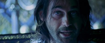 Movie still from “Bad Boys II” (2003), directed by Michael Bay – A person with long hair and blue eyes; Close Up shot, Over the shoulder angle