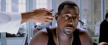Movie still from “Bad Boys II” (2003), directed by Michael Bay – A person with a hand on a man's shoulder; Close Up shot, Over the shoulder angle