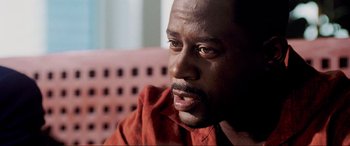 Movie still from “Bad Boys II” (2003), directed by Michael Bay – A person sitting on a couch; Close Up shot, Over the shoulder angle
