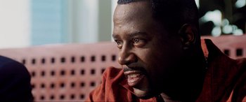 Movie still from “Bad Boys II” (2003), directed by Michael Bay – A person sitting on a chair; Close Up shot, Over the shoulder angle