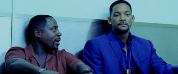 Movie still from “Bad Boys II” (2003), directed by Michael Bay – Two men sitting next to each other on a bench; Close Up shot, Over the shoulder angle