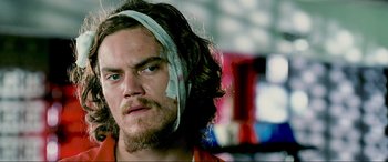 Movie still from “Bad Boys II” (2003), directed by Michael Bay – A person with a bandage on his head; Close Up shot, Low angle