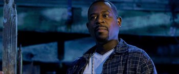Movie still from “Bad Boys II” (2003), directed by Michael Bay – A person wearing a plaid shirt; Close Up shot, Low angle