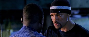 Movie still from “Bad Boys II” (2003), directed by Michael Bay – Two men talking to each other in a dark room; Close Up shot, Over the shoulder angle
