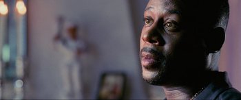 Movie still from “Bad Boys II” (2003), directed by Michael Bay – A man's face in a dark room; Close Up shot, Low angle