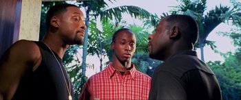 Movie still from “Bad Boys II” (2003), directed by Michael Bay – A group of men standing next to each other in front of trees; Medium shot, Low angle