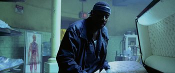 Movie still from “Bad Boys II” (2003), directed by Michael Bay – A man wearing a black hat and a black jacket; Medium shot, Low angle