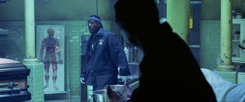 Movie still from “Bad Boys II” (2003), directed by Michael Bay – A man standing in front of a pot in a kitchen; Medium shot, Over the shoulder angle