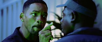 Movie still from “Bad Boys II” (2003), directed by Michael Bay – A man with green eyes is pointing at another man's face; Close Up shot, Over the shoulder angle