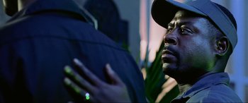 Movie still from “Bad Boys II” (2003), directed by Michael Bay – A person holding an open umbrella; Close Up shot, Over the shoulder angle