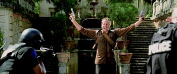 Movie still from “Bad Boys II” (2003), directed by Michael Bay – A man holding a cell phone in his hand; Medium shot, Low angle