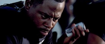 Movie still from “Bad Boys II” (2003), directed by Michael Bay – A person holding a cell phone; Close Up shot, Low angle