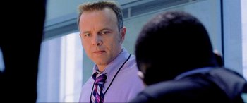 Movie still from “Bad Boys II” (2003), directed by Michael Bay – A man wearing a purple shirt and a purple tie; Close Up shot, Low angle