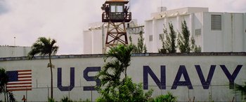 Movie still from “Bad Boys II” (2003), directed by Michael Bay – Two men standing on top of a tower next to a building; Extreme Wide shot, Low angle