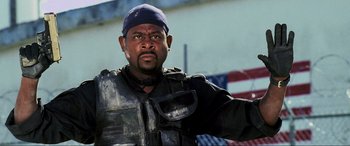 Movie still from “Bad Boys II” (2003), directed by Michael Bay – A man in a black jacket and a blue hat; Close Up shot, Low angle