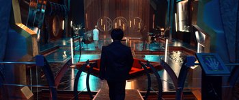 Movie still from “Barb and Star Go to Vista Del Mar” (2021), directed by Josh Greenbaum – A man in a suit is walking down a ramp; Wide shot, High angle