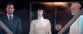 Movie still from “Barb and Star Go to Vista Del Mar” (2021), directed by Josh Greenbaum – A woman in a white dress standing in front of a mirror; Medium shot, Low angle