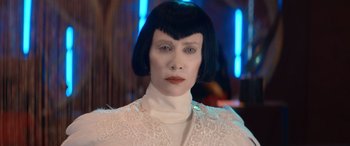 Movie still from “Barb and Star Go to Vista Del Mar” (2021), directed by Josh Greenbaum – A woman in a white shirt and black wig; Close Up shot, Low angle