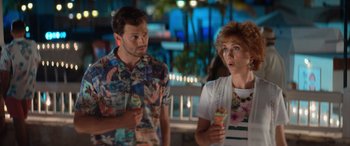 Movie still from “Barb and Star Go to Vista Del Mar” (2021), directed by Josh Greenbaum – A man and a woman standing next to each other; Medium shot, Over the shoulder angle