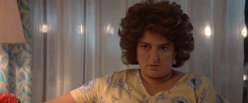 Movie still from “Barb and Star Go to Vista Del Mar” (2021), directed by Josh Greenbaum – A person wearing a yellow shirt; Close Up shot, Low angle