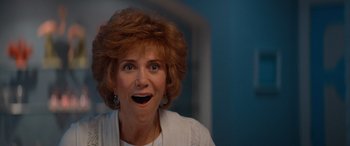 Movie still from “Barb and Star Go to Vista Del Mar” (2021), directed by Josh Greenbaum – An older woman with a surprised look on her face; Close Up shot, Low angle