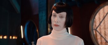 Movie still from “Barb and Star Go to Vista Del Mar” (2021), directed by Josh Greenbaum – A woman with a black wig and a white shirt; Close Up shot, Over the shoulder angle