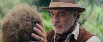 Movie still from “Barb and Star Go to Vista Del Mar” (2021), directed by Josh Greenbaum – An older man in a hat looking in the mirror; Close Up shot, Over the shoulder angle