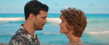 Movie still from “Barb and Star Go to Vista Del Mar” (2021), directed by Josh Greenbaum – A man and a woman face to face near the ocean; Close Up shot, Over the shoulder angle