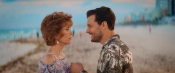 Movie still from “Barb and Star Go to Vista Del Mar” (2021), directed by Josh Greenbaum – A man and a woman talking on the beach; Close Up shot, Over the shoulder angle