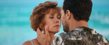 Movie still from “Barb and Star Go to Vista Del Mar” (2021), directed by Josh Greenbaum – A man and a woman touching their faces; Close Up shot, Over the shoulder angle