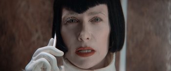 Movie still from “Barb and Star Go to Vista Del Mar” (2021), directed by Josh Greenbaum – A person talking on a cell phone; Close Up shot, Low angle