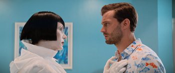 Movie still from “Barb and Star Go to Vista Del Mar” (2021), directed by Josh Greenbaum – A man and a woman face to face in front of a blue wall; Close Up shot, Over the shoulder angle