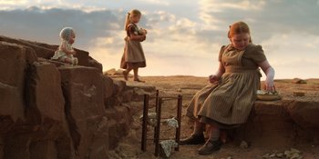 Movie still from “Barbie” (2023), directed by Greta Gerwig – Two girls are standing on a dirt hill; Wide shot, Low angle