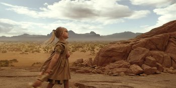 Movie still from “Barbie” (2023), directed by Greta Gerwig – A little girl standing in the middle of the desert; Wide shot, Low angle