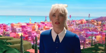 Movie still from “Barbie” (2023), directed by Greta Gerwig – A woman with blonde hair wearing a blue dress; Close Up shot, Over the shoulder angle