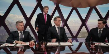 Movie still from “Barbie” (2023), directed by Greta Gerwig – Two men in business suits sitting at a table; Medium shot, Low angle