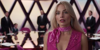 Movie still from “Barbie” (2023), directed by Greta Gerwig – A woman in a pink dress and a man in a suit; Close Up shot, Over the shoulder angle