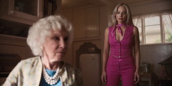 Movie still from “Barbie” (2023), directed by Greta Gerwig – A woman standing next to an older woman in front of a mirror; Medium shot, Over the shoulder angle
