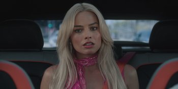 Movie still from “Barbie” (2023), directed by Greta Gerwig – A woman sitting in the back seat of a car; Close Up shot, Over the shoulder angle