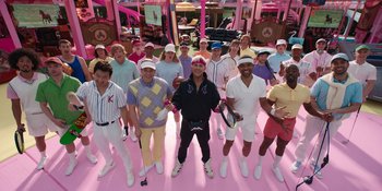 Movie still from “Barbie” (2023), directed by Greta Gerwig – A group of people standing around each other holding rackets; Wide shot, High angle