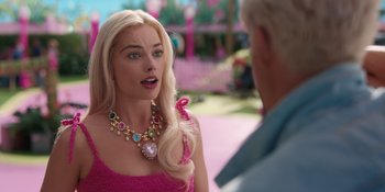 Movie still from “Barbie” (2023), directed by Greta Gerwig – A woman in a pink dress talking to a man in a pink shirt; Close Up shot, Over the shoulder angle