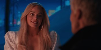 Movie still from “Barbie” (2023), directed by Greta Gerwig – A woman with long blonde hair is talking to a man; Close Up shot, Over the shoulder angle