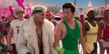 Movie still from “Barbie” (2023), directed by Greta Gerwig – Two men are standing together and one is wearing a fur coat and the other is wearing a green tank top; Medium shot, Over the shoulder angle