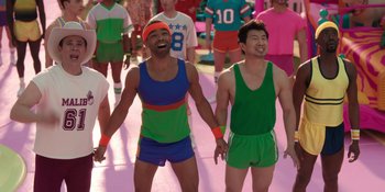 Movie still from “Barbie” (2023), directed by Greta Gerwig – A couple of men holding hands while standing next to each other; Wide shot, High angle